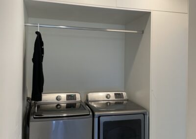 Custom storage space around a washer and dryer