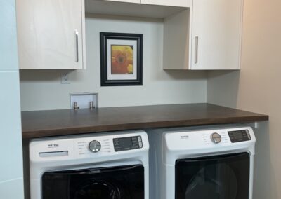 Custom cabinets and work area above washer and dryer in Nelson BC