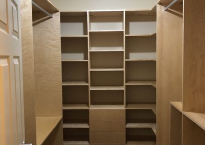 Large walk in closet with a custom a full custom shelving and storage space.