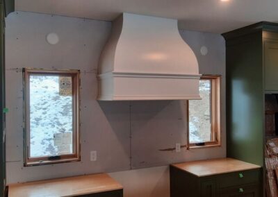 Custom kitchen an hood fan being installed in Nelson BC