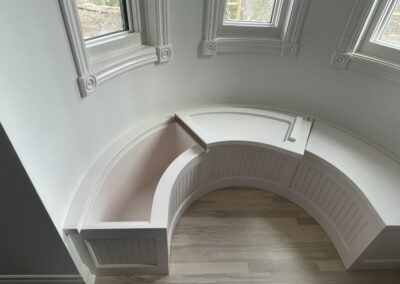 Curved, decorative, wooden window seats by Steinegg Cabinets