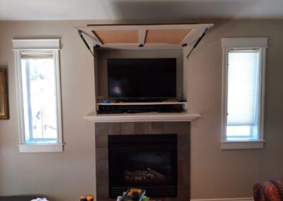 Photo of a custom tv area behind a lifting wall