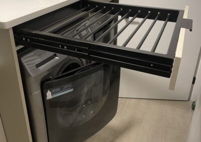 Custom built drawers and workspace surrounding a washing machine.