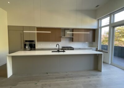 Custom kitchen with large island and modern lighting