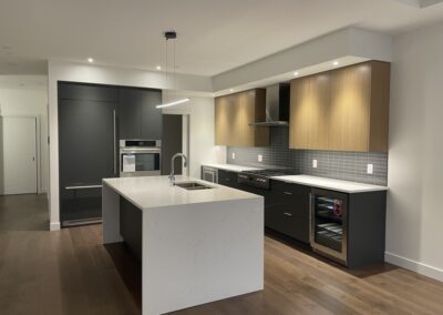 Custom kitchen with lots of lighting and dark wood finishes