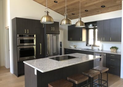 Custom kitchen with an island and dark wood finishes.