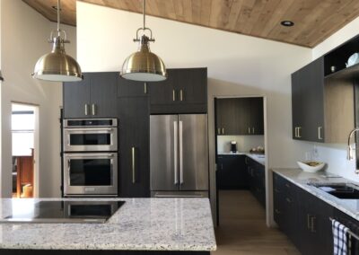 Custom kitchen with dark cupboard doors, by Steinegg Cabinets