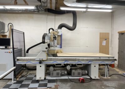 Photo of a CNC wood cutting machine in the Steinegg Cabinets shop in Nelson BC