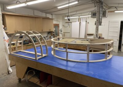 Photo of a curved custom pieces of furniture being built by Steinegg Cabinets in their shop.