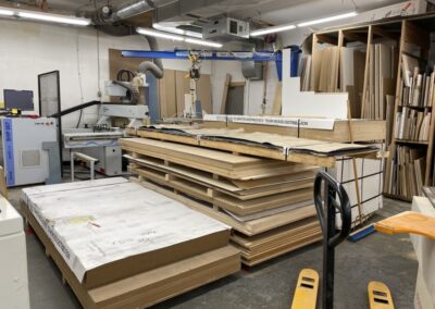 Photo of stacks of orgainzed wood in the Steinegg Cabinets shop. Ready for building new custom cabinets.